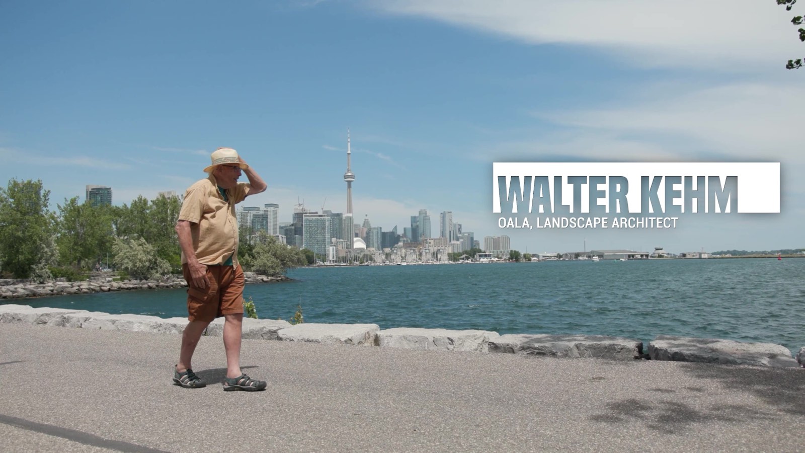 Landscape architect Walter Kehm on a Toronto beach with the CN Tower skyline for documentary video production.