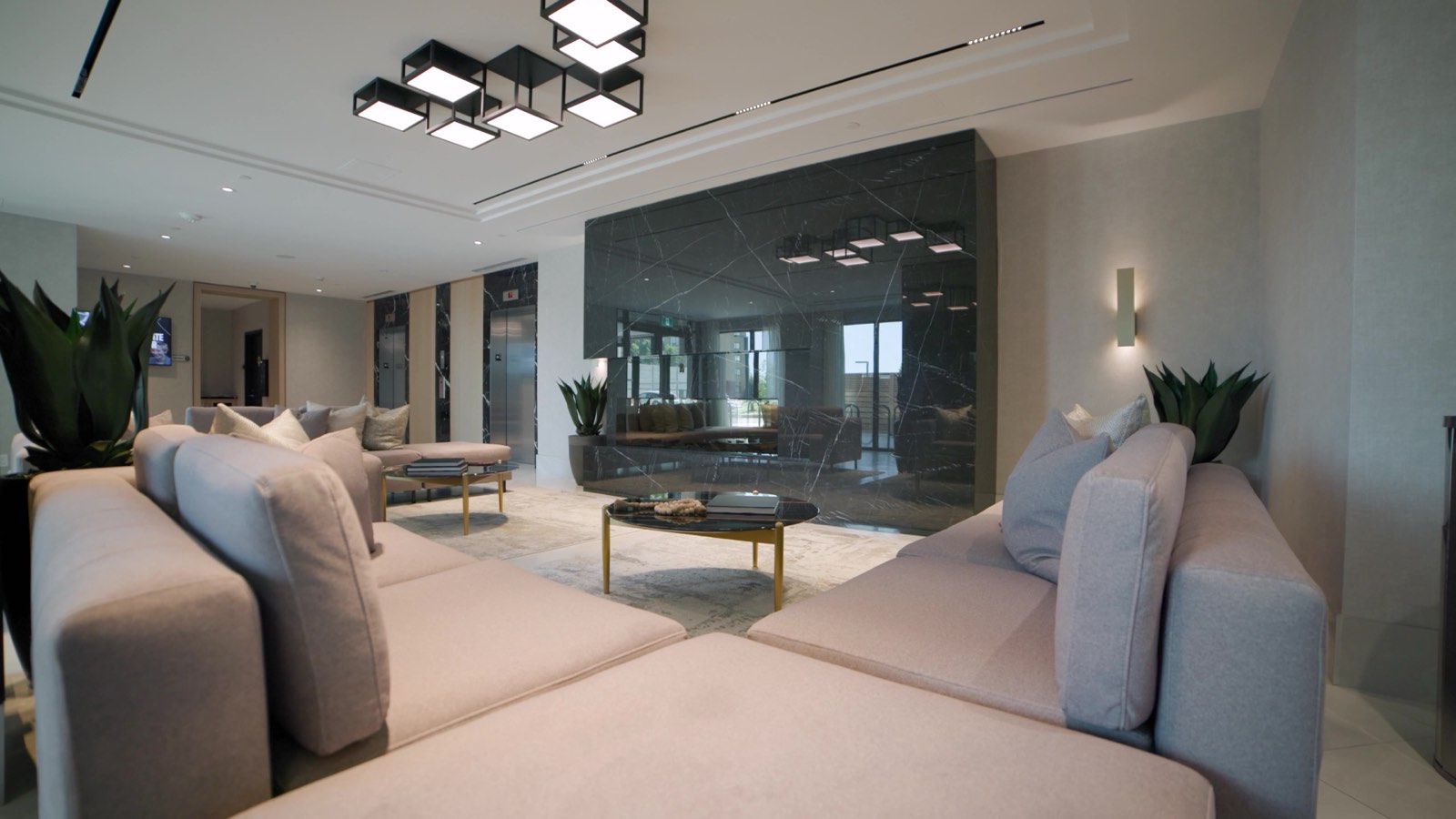 Modern commercial building lobby in Toronto featuring a grey, black, and white minimalist interior design.