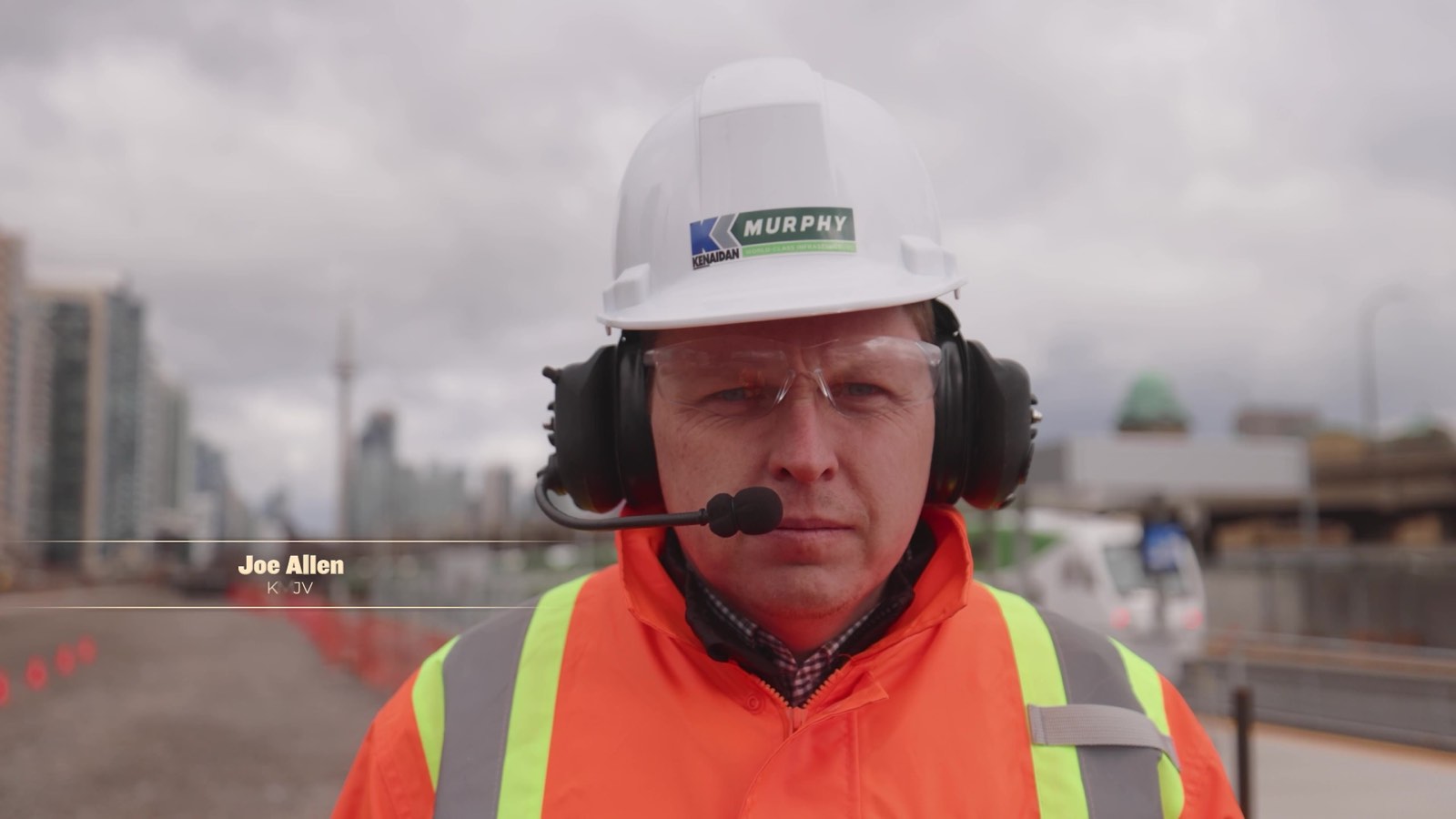 Close-up documentary photo of Joe Allen wearing a safety hard hat and protective gear on a Toronto job site.